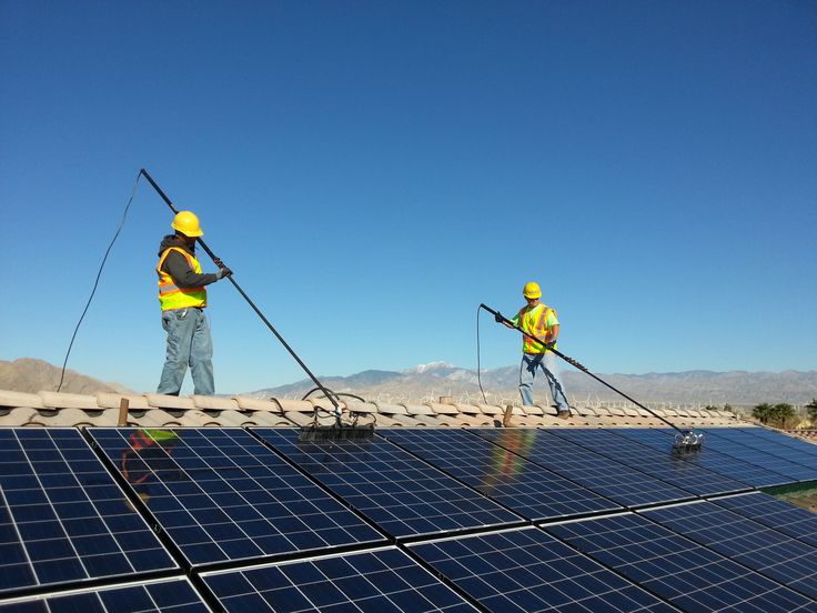 Solar operation and maintenance technician servicing panels